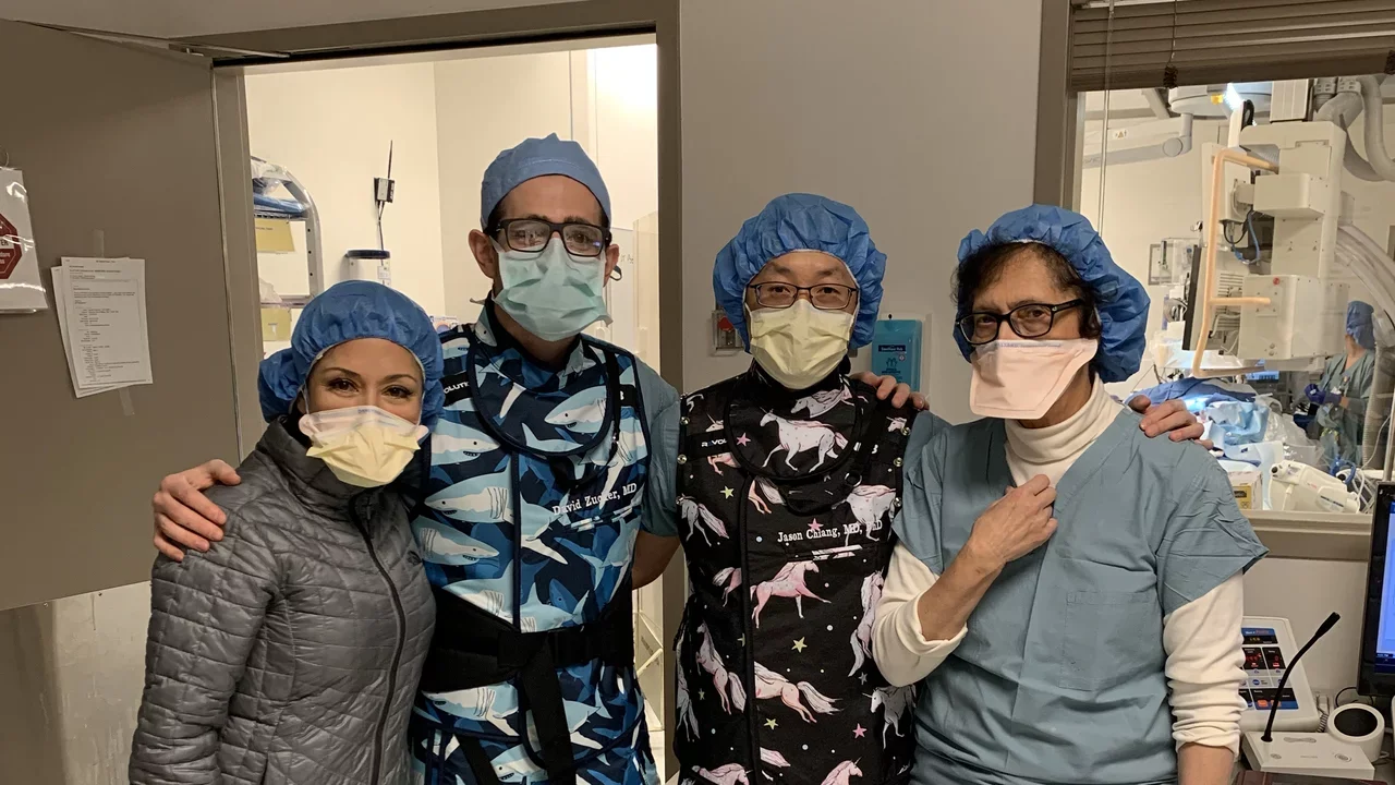 team members in the radiology IR suite gowned up in scrubs