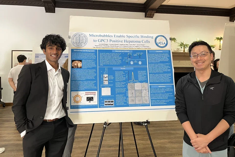 aravinth ruppa and jason chiang presenting a poster