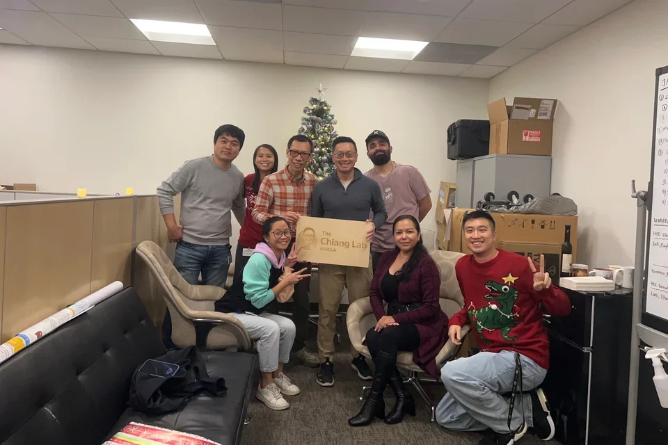 team christmas photo with chiang lab wooden placard